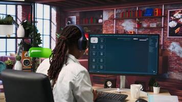 Woman at home using AI software turning text prompt into photos, drinking coffee. Girl in apartment enjoying hot beverage and using text to image artificial intelligence generator, camera B video