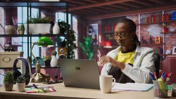 Remote employee pausing work done on laptop at home to pensive thinking. Teleworker in apartment feeling bored by repetitive tasks, stopping work on notebook to daydream, camera A video