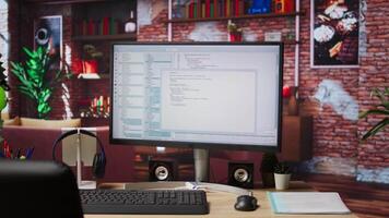 Programming code executing software UI on computer monitor in apartment office. Close up of coding application on PC screen used to write and test code in modern apartment, jib down shot video