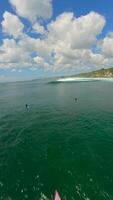 FPV flight over surfers waiting for waves in the ocean waters of Bali, Indonesia video