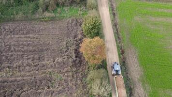 drone aerial view of a tractor driving on a farm track video