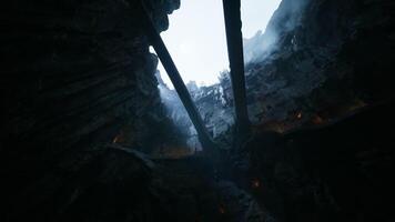 View of rocky canyon with thin bridges above and mist surrounding video