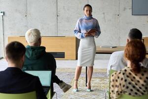 A businesswoman leader guiding a meeting with her colleagues, discussing business challenges, marketing strategies, and new plans for growth and success photo
