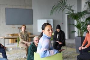 A diverse group of business professionals sits attentively in a modern office, actively participating in a training session led by an instructor, focusing on the latest technological advancements in photo