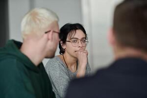 A diverse multiethnic business team engages in a collaborative meeting, discussing strategies and solutions in a modern office setting photo