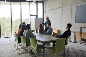 A diverse multiethnic business team engages in a collaborative meeting, discussing strategies and solutions in a modern office setting photo