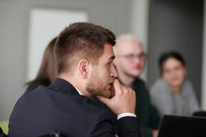 A diverse multiethnic business team engages in a collaborative meeting, discussing strategies and solutions in a modern office setting photo