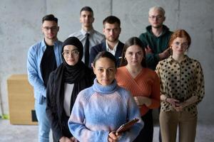 A diverse and determined team of business professionals stands confidently in an office, ready to tackle new business plans and challenges with a focus on success and growth photo