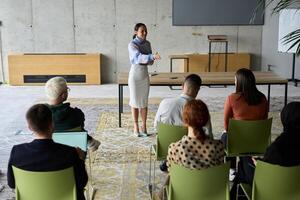 A businesswoman leader guiding a meeting with her colleagues, discussing business challenges, marketing strategies, and new plans for growth and success photo