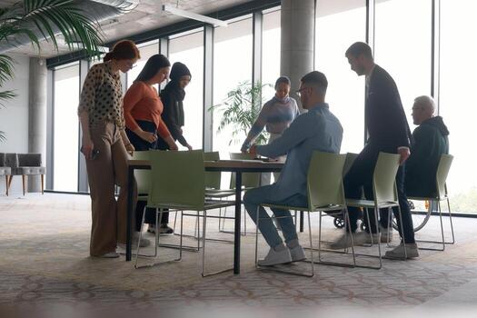 A diverse multiethnic business team engages in a collaborative meeting, discussing strategies and solutions in a modern office setting photo