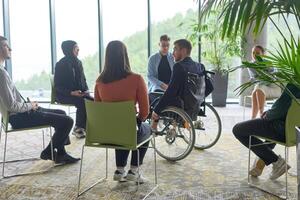 Corporate business team meeting with a manager or coach. Group of happy diverse, multiracial people sitting in a circle photo