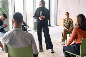 Corporate business team meeting with a manager or coach. Group of happy diverse, multiracial people sitting in a circle photo