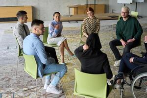 Corporate business team meeting with a manager or coach. Group of happy diverse, multiracial people sitting in a circle photo