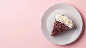 Piece of chocolate cake with vanilla cream, pink background top view with copy space. Tasty dessert on a plate photo