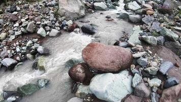 Exploring the Serene Beauty of a River Flowing Through Colorful Stones in a Tranquil Setting video