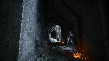 Exploration of a dimly lit abandoned mine tunnel with flickering candles video