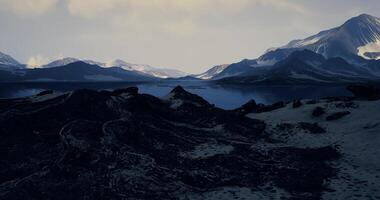 Breathtaking view of mountains reflecting in calm water at twilight hours video