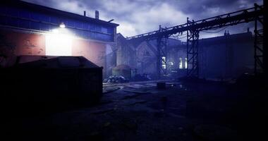 Ruined warehouse illuminated by a single light in an eerie twilight setting video