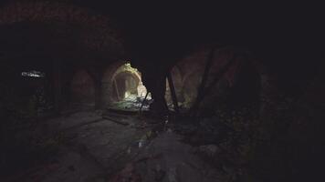 Exploring an abandoned structure illuminated by faint light in a dark space video