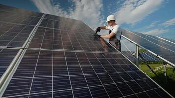 Engineer installing solar panels on a sunny day using a drill video