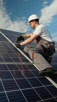 Engineer installing solar panels with a power drill outdoors video
