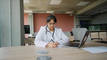 Tired Indian doctor working late after a long day at the office video