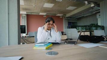 Tired Indian doctor after a long clinic day, dealing with stress video