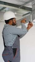 Indian worker installing ventilation system in office building video