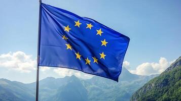 European Union Flag Fluttering Against Scenic Mountain Background in Clear Sunny Weather photo