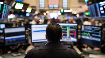 Financial Trader Analyzing Stock Market Data on Multiple Screens at a Busy Stock Exchange photo