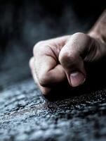 Clenched Fist Against Dark Grungy Background Reflecting Determination And Anger photo