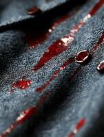 Dark Fabric Splattered with Red Liquid Creating Dramatic and Mysterious Mood photo