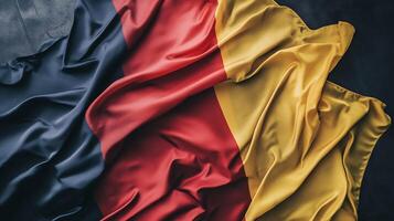Closeup of Silk Fabric in Bold Red Yellow and Black Colors Creating Waves and Texture photo