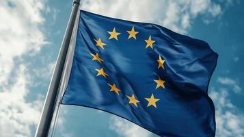 European Union Flag with Yellow Stars on Blue Background Against Cloudy Sky photo