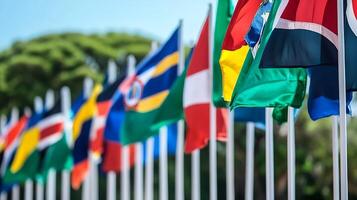 International Flags Displayed Against a Lush Greenery Background at a Global Summit or Event photo