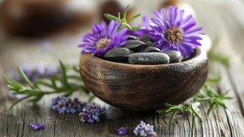 Serene Spa Setting with Purple Flowers and Smooth Black Stones in Wooden Bowl on Rustic Table photo