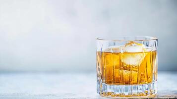 Crystal Glass of Whiskey on Ice on a Light Background with Elegant Presentation photo