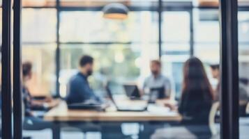 Blurred Image of Colleagues in Modern Office Discussing Work in Professional Atmosphere photo