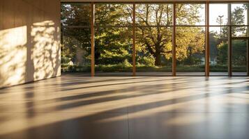 Sunlit Empty Room with Floor-to-Ceiling Windows Overlooking Autumn Trees photo