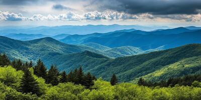 A view of the mountains and forest with clouds photo