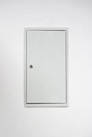 Door with a simple design against a white wall in a minimalistic setting photo