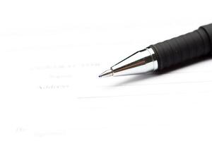 Close-up of pen on contract photo