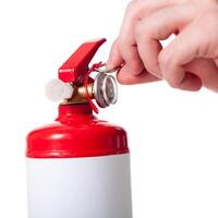 Man using fire extinguisher isolated on white photo