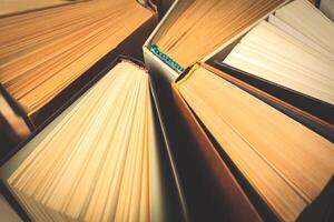 Old and used hardback books or text books seen from above. photo