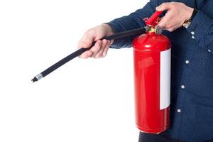 Man using fire extinguisher isolated on white photo