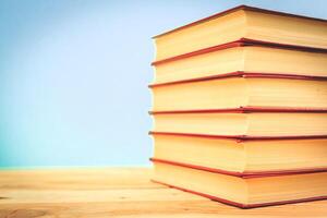 Vintage old books on wooden deck table photo
