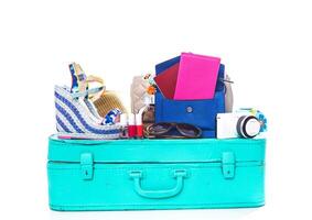 Packing suitcase for trip isolated on white photo