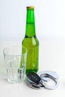 Drunk Driving Concept - Beer, Keys and Handcuffs photo