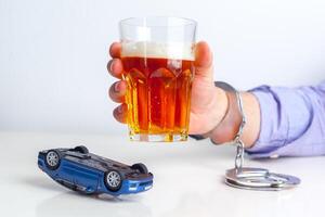 Drunk Driving Concept - Beer, Keys and Handcuffs photo