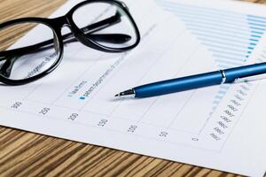 Financial paper charts and graphs on the table. photo